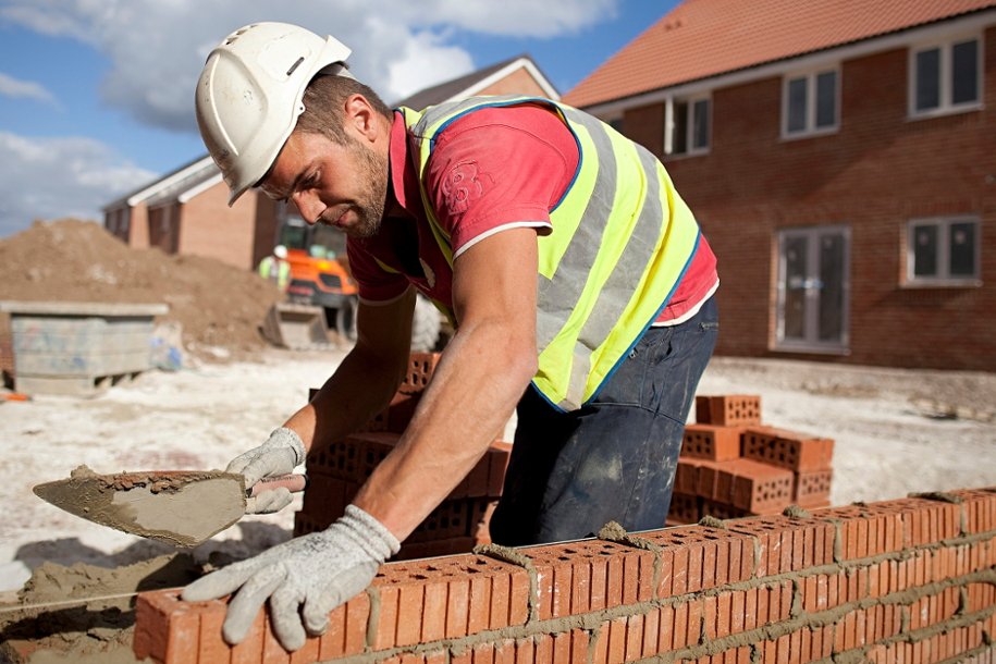 Building team laying brickwork on site