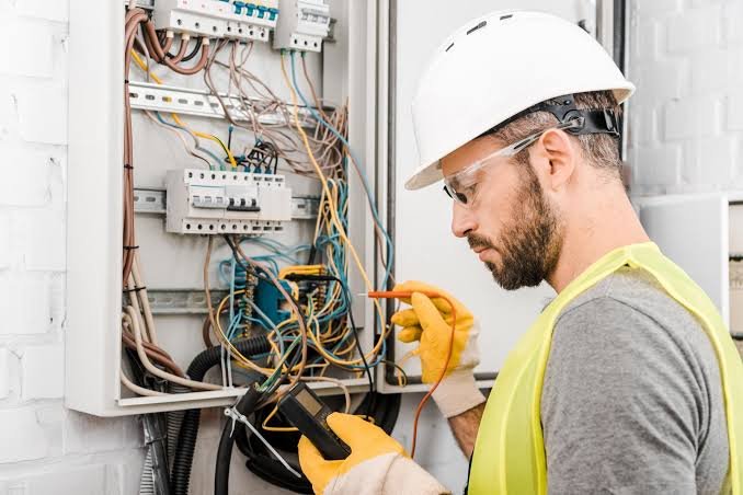 Electrician testing a distribution panel