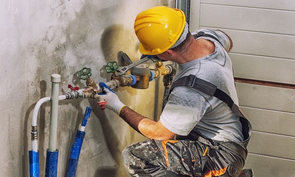 Plumber repairing a sink and pipework